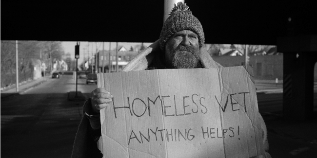 homeless veteran with sign