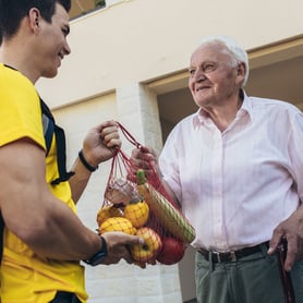A senior receives food charity donation 
