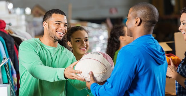 Volunteer hands out turkey at food shelf charity