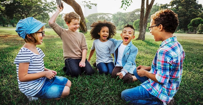 Children gathered in a circle outside, MN is facing a child care crisis.