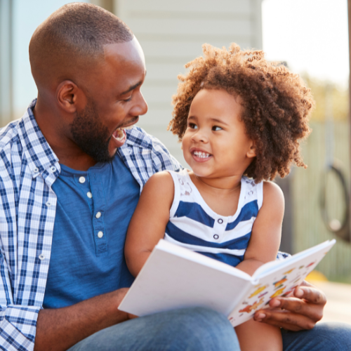 Dad & daughter with book