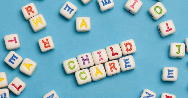 Colorful tiles on a blue background that spells the words child care