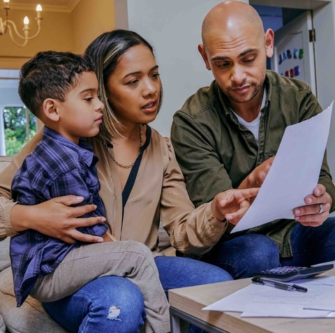 Father, Mother & Son looking at paperwork