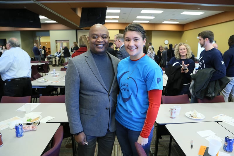 two people smiling at the camera