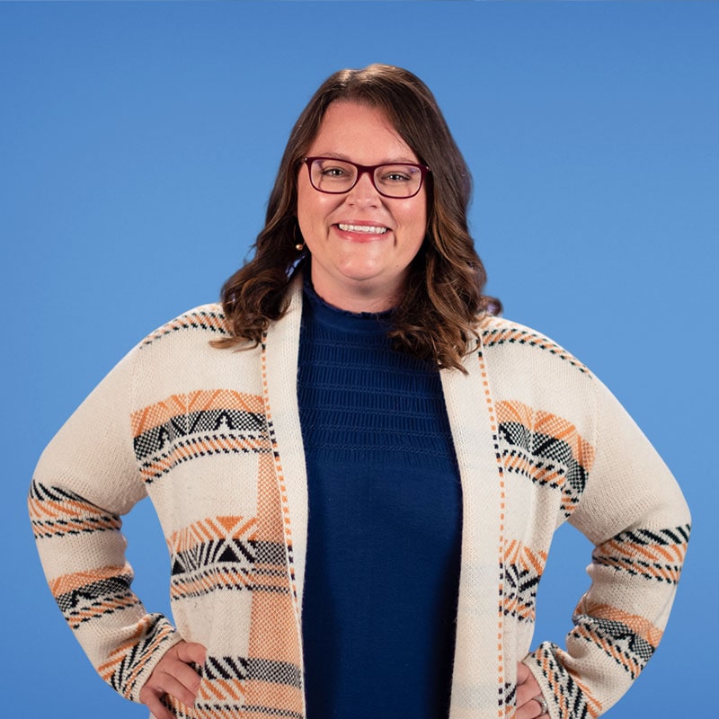 woman with hands on hips smiling