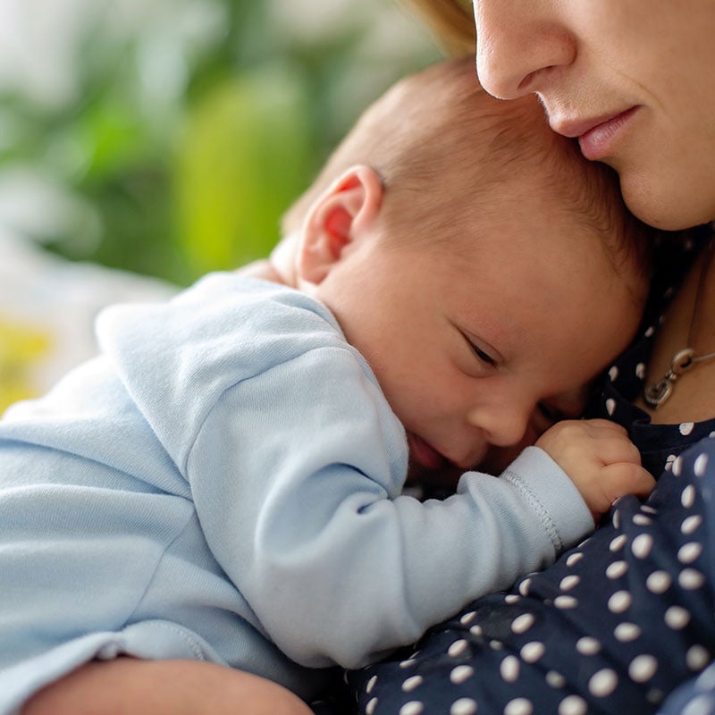 mother cradling baby