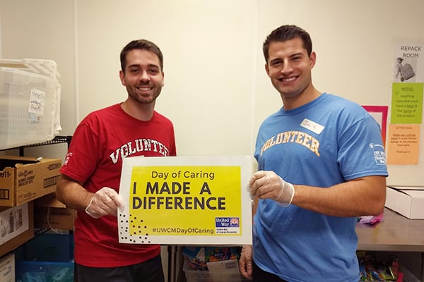 Volunteers holding a sign