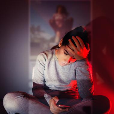 Girl looking at phone with red lighting