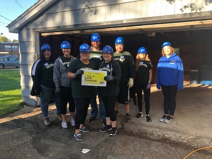 day of caring volunteers in front of garage