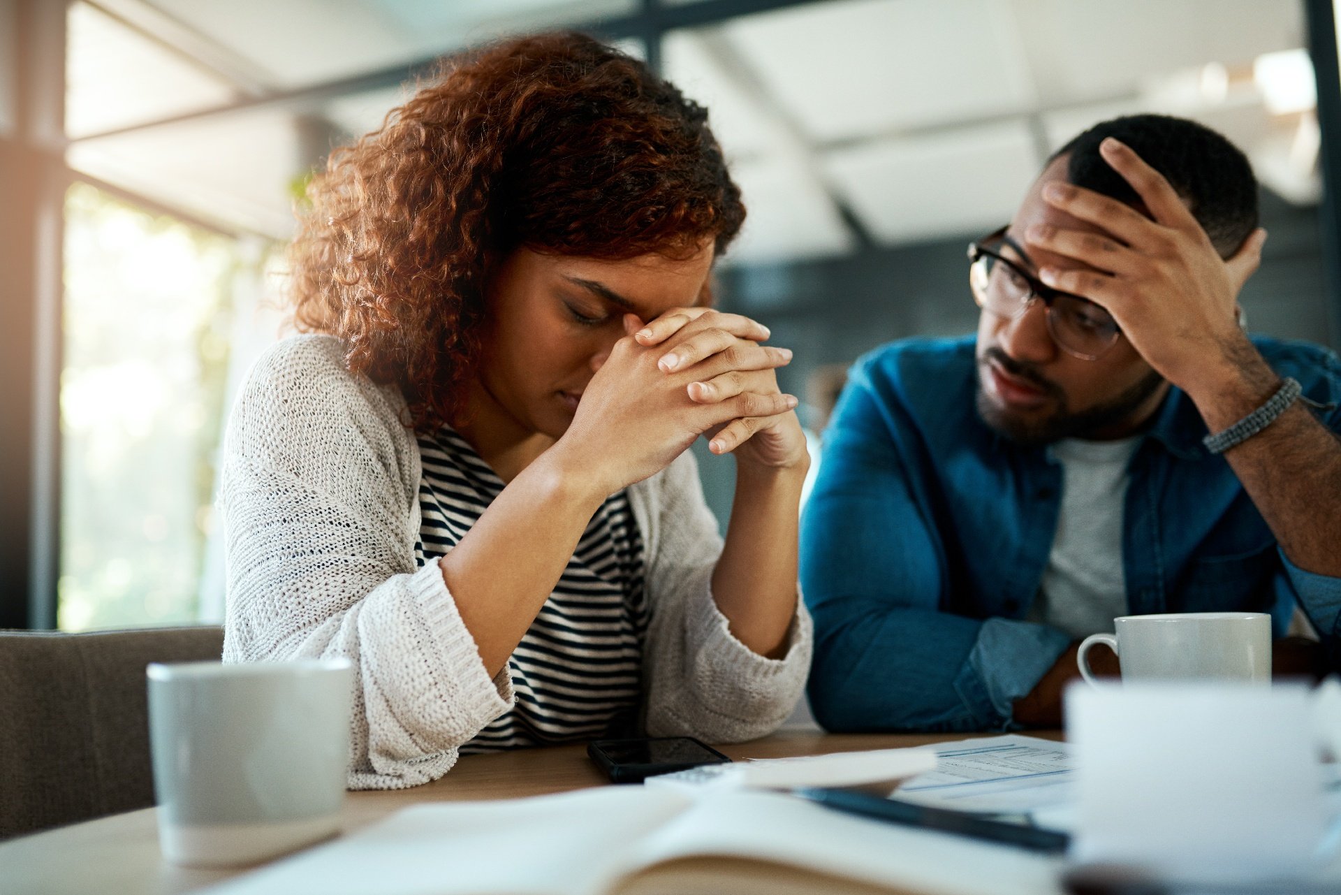 Stressed couple reviewing finances