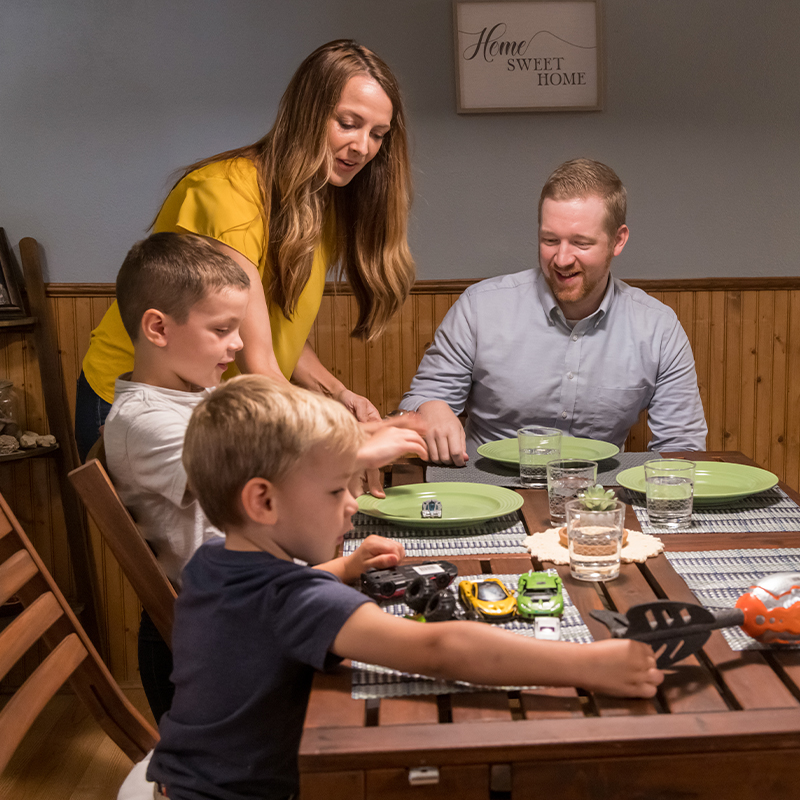 Family smiling and enjoying a meal together