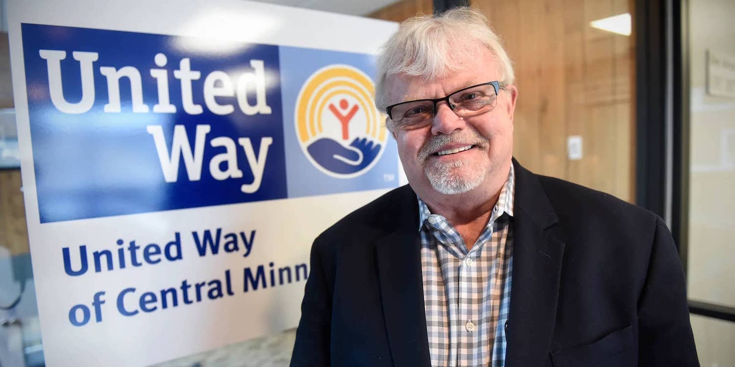 larry in front of united way central minnesota sign