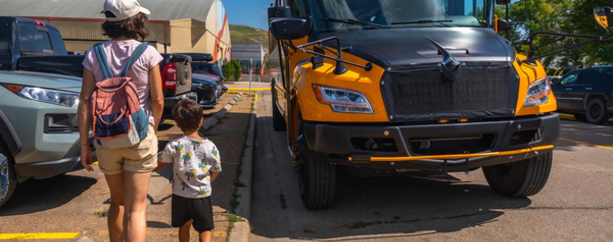 Parent walking a child to the school bus